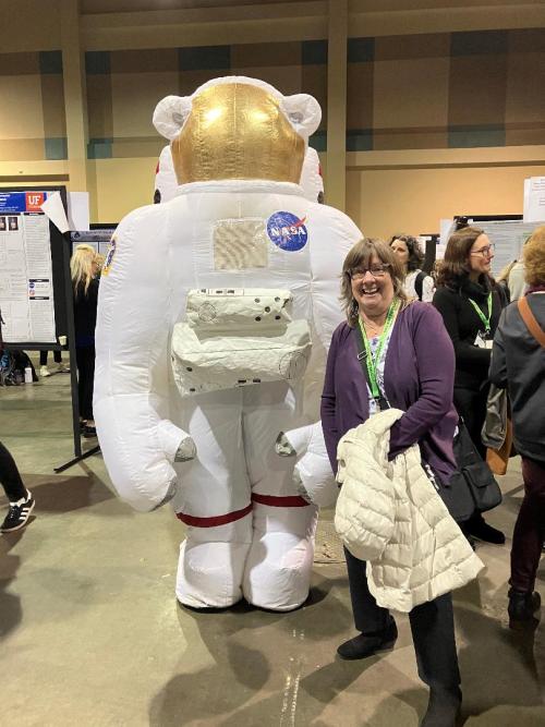 Astronaut blow up character and professor at a conference.