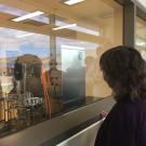 Karen McDonald gazing at a bioreactor.